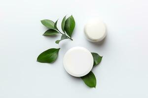 Organic cosmetic products with green leaves on white background. Flat lay. photo
