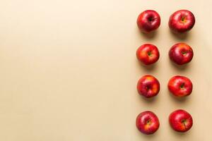 Many red apples on colored background, top view. Autumn pattern with fresh apple above view with copy space for design or text photo