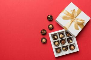 White box with chocolates candies and golden tape. top view with copy space photo