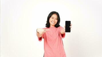 Happy asian woman showing smartphone with blank screen on white background photo