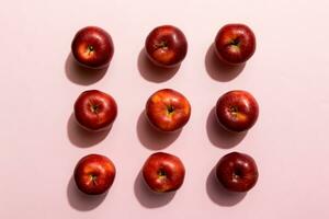 Many red apples on colored background, top view. Autumn pattern with fresh apple above view photo