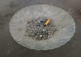 burn out cigarette. cigarette ash on a plate photo
