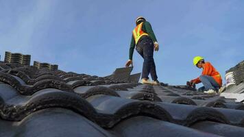 Roofing technician with install new CPAC roof, roofing tools, electric drill used on a new roof with CPAC roof construction concept. video