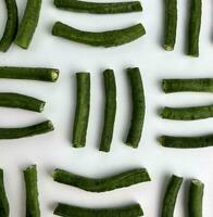 Close up green long beans, Asparagus, snake, pea, or Yardlong bean with line pattern composition layout. Vigna unguiculata subs sesquipedalis. Raw vegetable food isolated on plain background top view photo