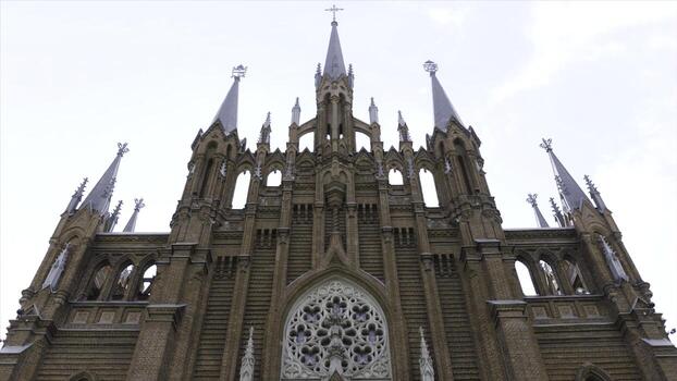 The Cathedral Basilica of the Immaculate Conception on cloudy sky background. Action. Bottom view of a beautiful church, concept of architecture and religion. photo