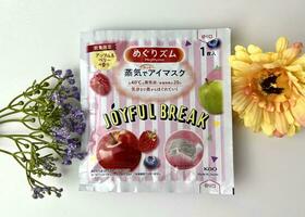 Jakarta, Indonesia - December 7th, 2023 - Megrhythm kao japan brand warming eye mask for tired eyes, joyful break unique sweet variant scent. Gentle steam eye mask isolated with flower decorations photo