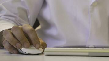 Closeup of a man using computer. His shirt and tie in background photo