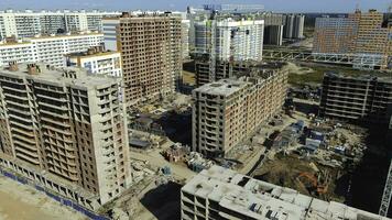 Development of residential areas. Construction of new residential complexes, roads and other infrastructure in summer against blue sky photo