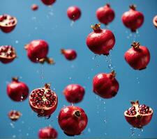 AI generated Falling pomegranate fruits with water drops on blue background photo