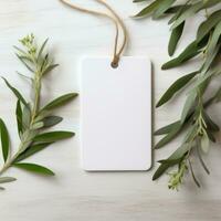 AI generated white blank tag with blank front realistic on a mockup template in a white wooden table with olive leaf branch photo