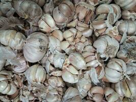 Pile of garlic for sale in the market. Garlic is used in almost every dish. has become a mandatory cooking spice. photo