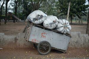 Cart containing plastic recycling sacks. photo