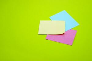 Blank colorful stickers on a light green background. photo