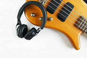 Marshall bluetooth headphones, wireless, and bass guitar on white background. photo