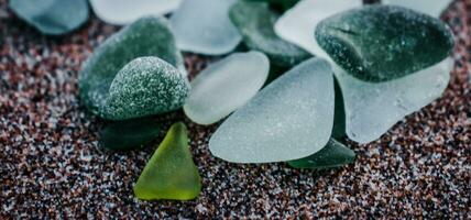 Sand mediterranean beach and stones photo. Glass stones from broken bottles polished by the sea. photo