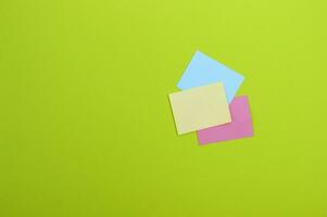 Blank colorful stickers on a light green background. photo