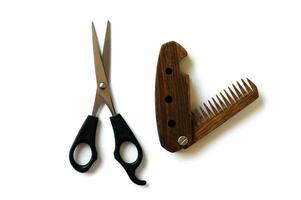 Male wooden comb and scissors for a haircut isolated on a white background. photo