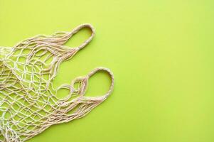 Reusable shopping bag on green background. photo