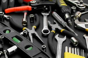 Many different tools for repair work on a black background. photo