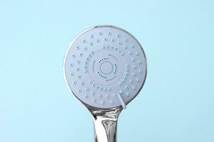 Shower head chrome coated multi-mode for the bathroom with hose on blue background. photo