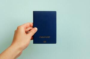 Biometric international passport in a female hand. photo