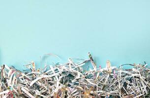 Shredded paper on light blue background. photo