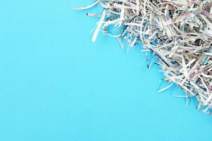 The shredded paper on light blue background. photo