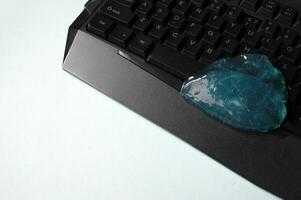 Blue soft gel cleaning dust on keyboard. photo