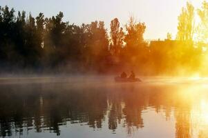 Two fisherman in a boat silhouette. photo