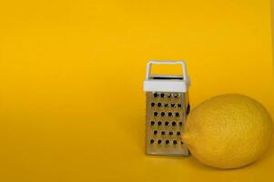 Fresh lemon and grater stainless. photo