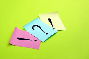 Question mark and exclamation mark stickers on light green background. photo