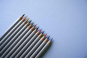 Color pencils lies on light blue background. Art concept photo