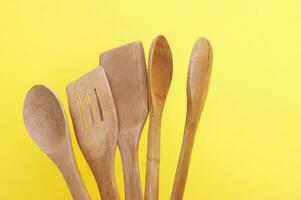 A set of bamboo dishes on a bright yellow background. photo