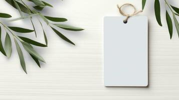 AI generated white blank tag with blank front realistic on a mockup template in a white wooden table with olive leaf branch photo