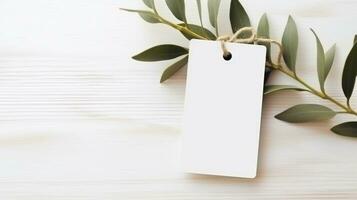 AI generated white blank tag with blank front realistic on a mockup template in a white wooden table with olive leaf branch photo