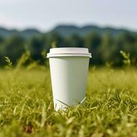 AI generated paper coffee cup with blank front, realistic on a mockup template in a green meadow, photo