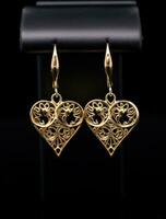 AI generated two gold earrings with intricate hearts design surrounded by lights, photo
