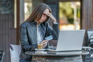 Frustrated woman losing money in online gaming photo