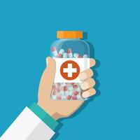 medicine bottle with red cross in hand of a doctor vector