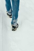 Rear view of Man Walking in Snow photo