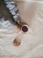 girls hand holding tea cup, cookie on table, cozy hugge concept. Pastel colors. High quality photo. photo