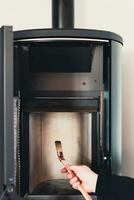 Man cleaning pellet stove with brush photo