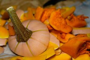 Freshly cut and peeled butternut, peelings for compost photo