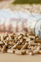 Pile of pellets with bag of granules in the background photo