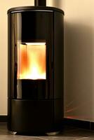 Modern domestic pellet stove, granules stove with flames photo