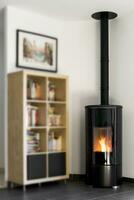 Modern domestic pellet stove, granules stove with flames and library photo