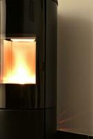 Modern domestic pellet stove, granules stove with flames photo