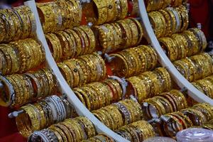 Indian rings and bracelets in silver and gold and jewelry on the counter in store. photo