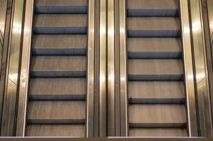 Moving metal stairs going up and down. photo