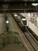 Train making a scheduled stop to pick up travellers. photo